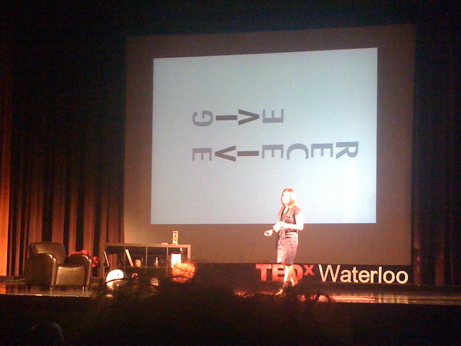 A presenter onstage at TEDxWaterloo