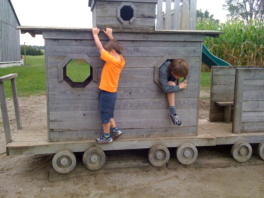 Kids enjoying outdoor playground train at Herrles