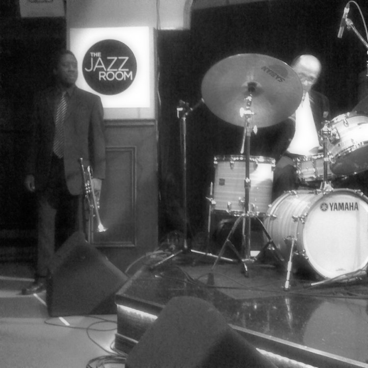 Kollage leader Archie Alleyne on drums along with trumpeter Alexander Brown, performing at The Jazz Room