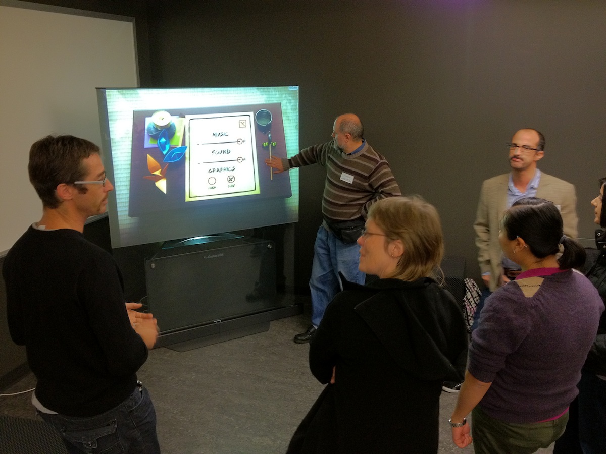 A group of people looking at a screen at a uxWaterloo event at Felt Lab