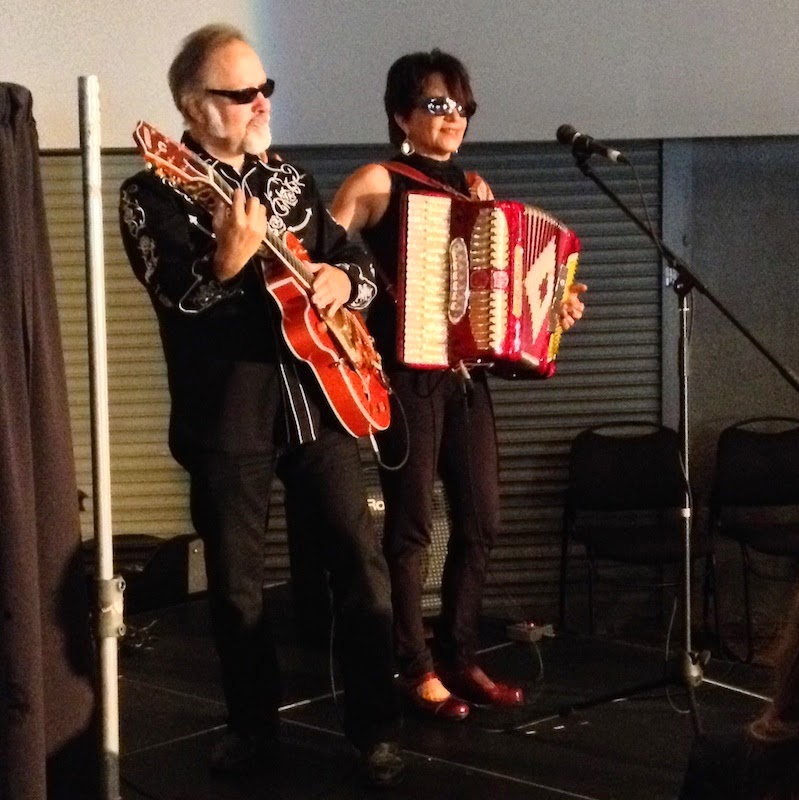 Silvia Dee and the Boyfriend, accordianist and guitarist, performing at Fluxible