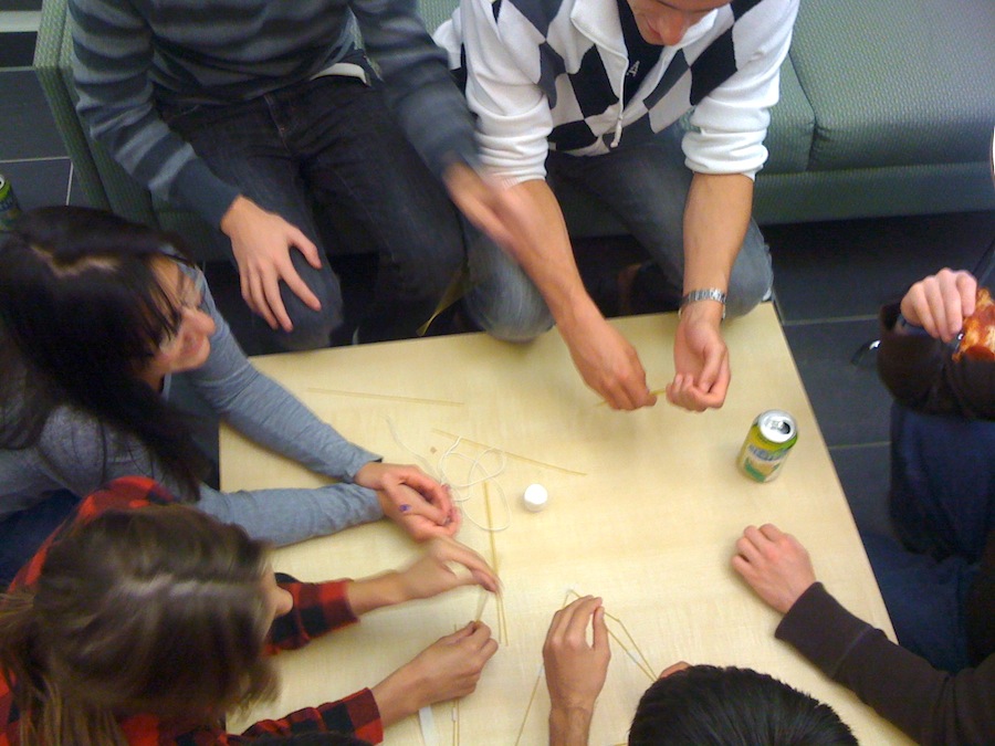 A group of people build a tower with spagehetti