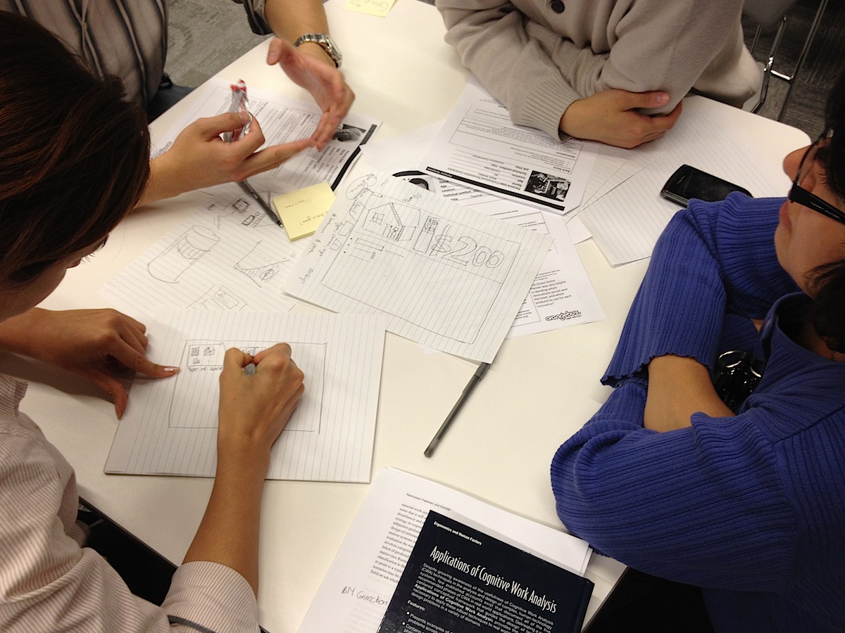 People sketching potential solutions for REEP at uxWaterloo event