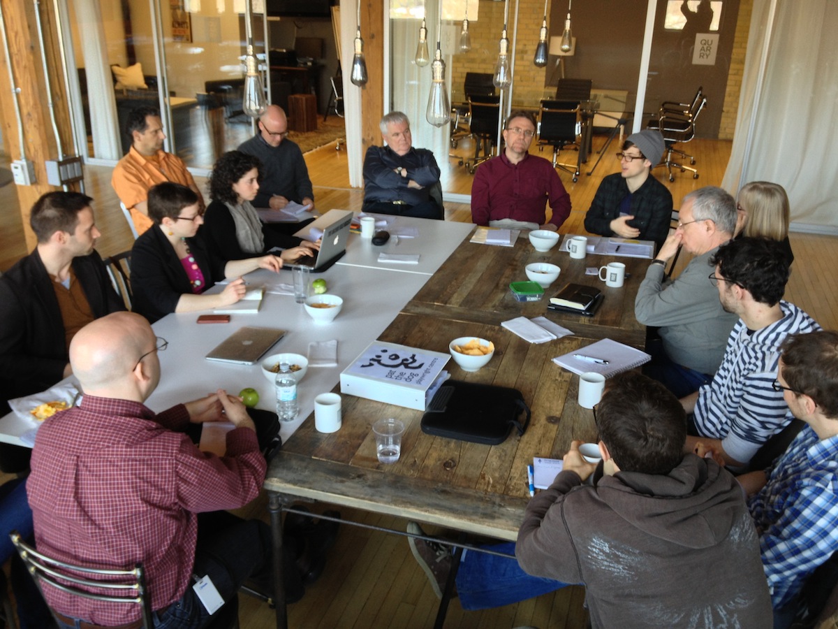 A group of people around a table at the Text + Tech event