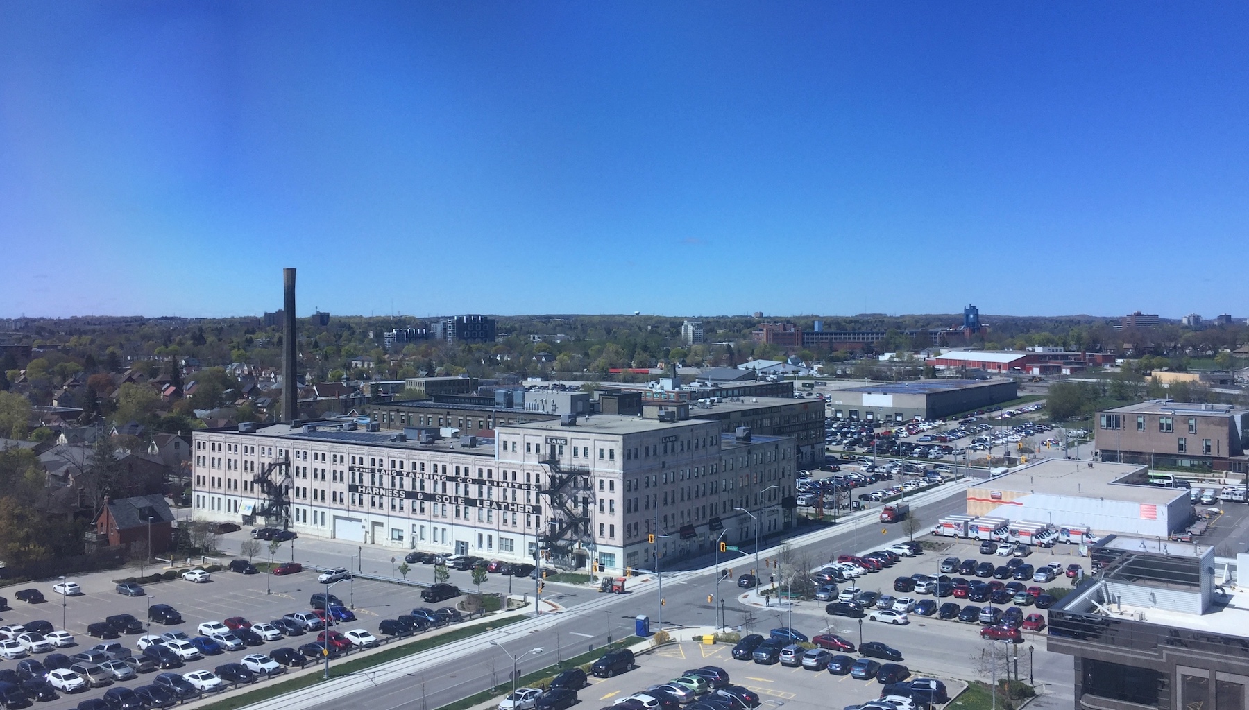 An aerial view of a neighborhood in Kitchener, including a large yellow-brick building known as The Tannery